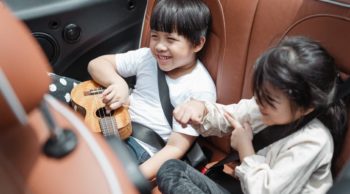 children in the passenger seat of a vehicle