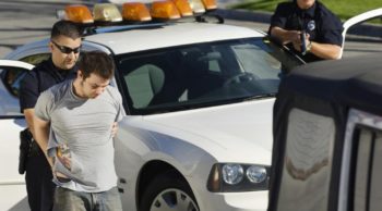 Police Officer Arresting Young Man