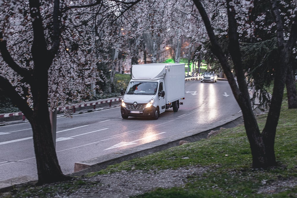 a commercial van cruising down the road