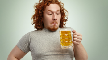 a man considering drinking a beer