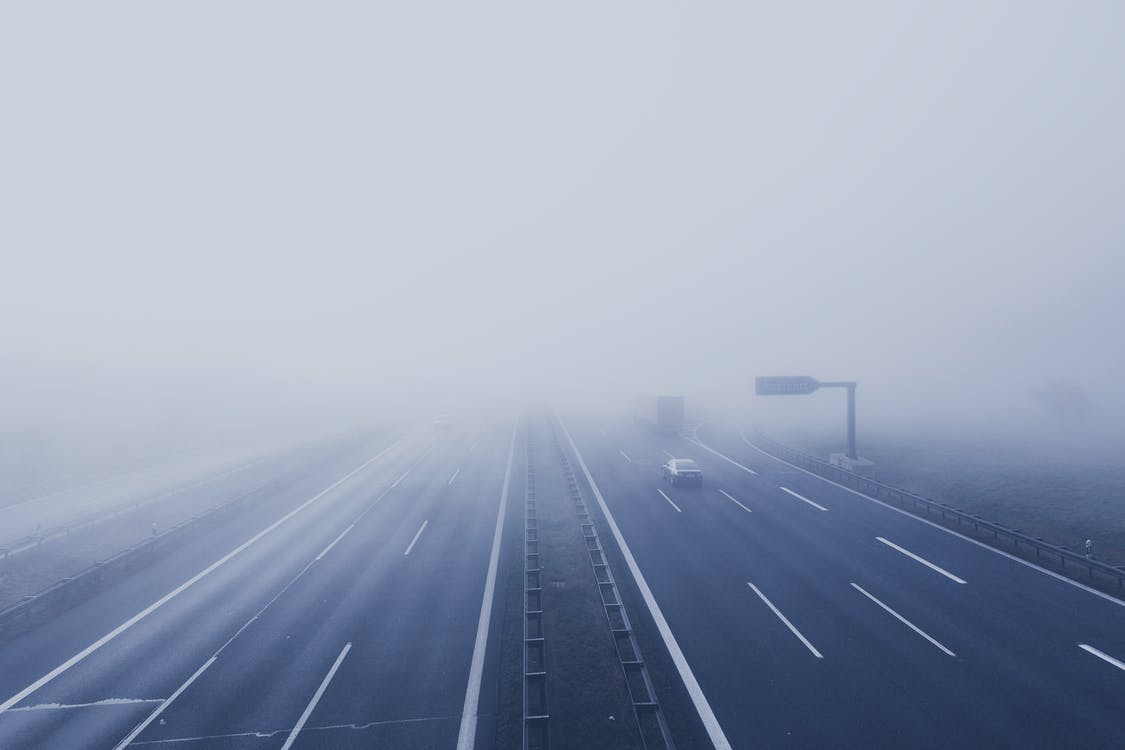 Vehicles driving on a freeway in fog