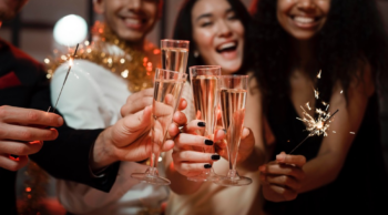 partiers holding champagn glasses and sparklers