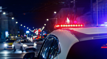 A police car about to give chase to white car