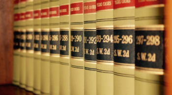 a sheft of law books of Texas Cases